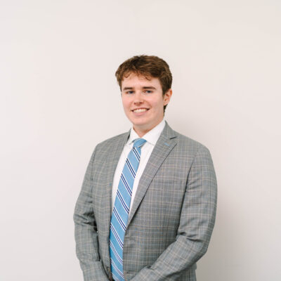 Carter Matt, a white man with short brown hair and a gray blazer and blue tie.
