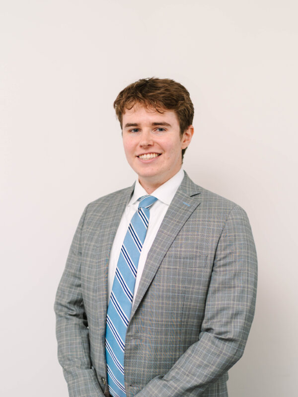 Carter Matt, a white man with short brown hair and a gray blazer and blue tie.