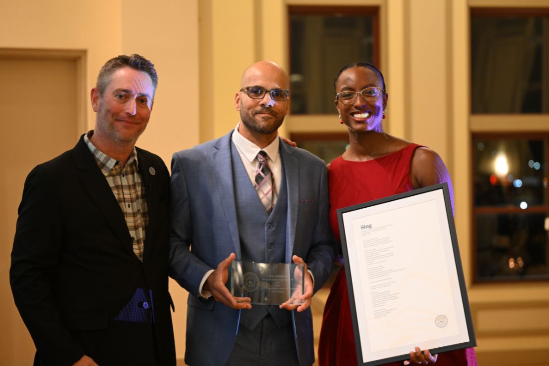 Jason (center) poses for a photograph with Steve Smith of Civic Nebraska and State Poet Jewel Rodgers.