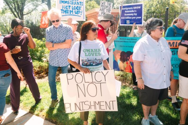 Sen. Margo Juarez and others rally outside the governor's mansion to oppose his plans for an immigrant detention center.