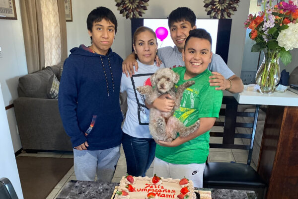 Lorena Alarcon-Alarcon poses for a photo with her sons for a recent birthday. The cake reads, Feliz Cumpleaños, mami!
