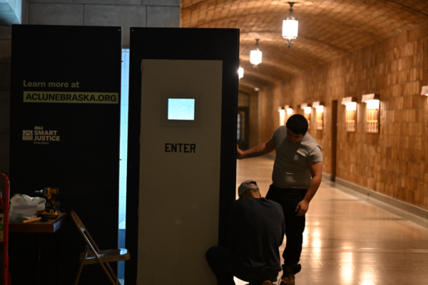 ACLU of Nebraska Policy Strategist Jason Witmer sets up a replica solitary confinement cell in the Nebraska State Capitol.