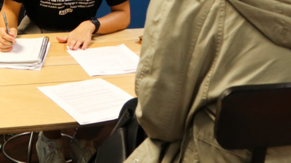 A team member assists with legal intake at a community event in Omaha.