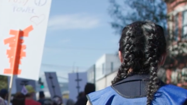 A photograph shows an ACLU legal observer in action. Courtesy ACLU of Oregon.