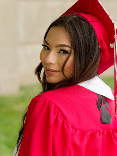 South Sioux City HS graduate Tiala Luong poses for a photograph in her gown and cap.
