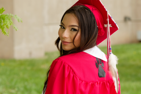 South Sioux City HS graduate Tiala Luong poses for a photograph in her gown and cap.