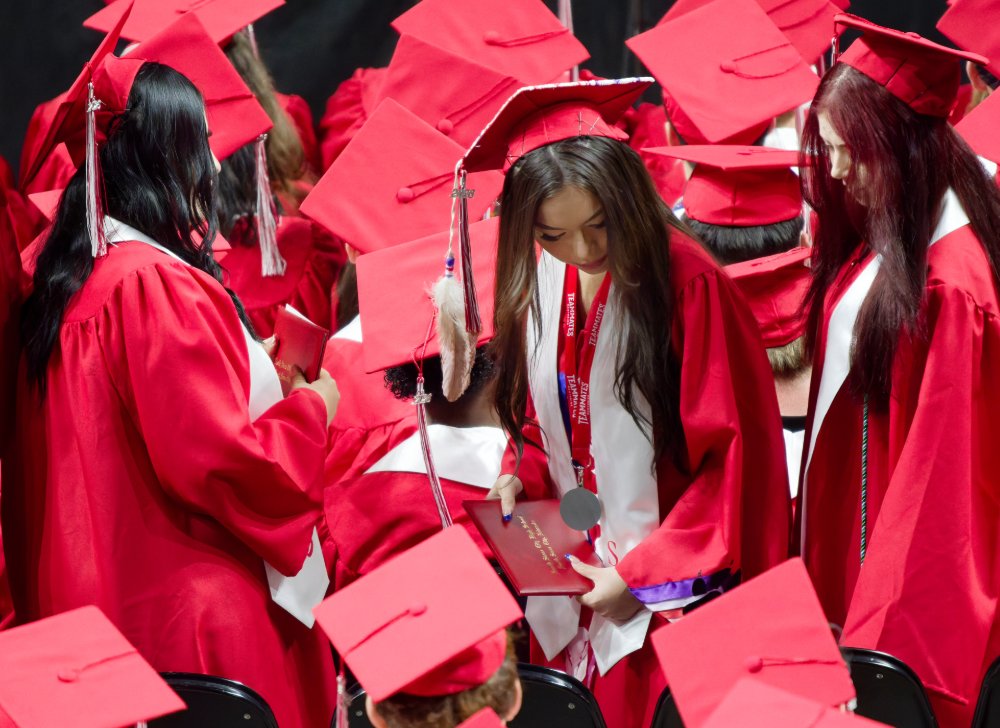 Tiala Luong sits down after receiving her diploma.