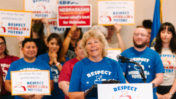 Respect Nebraska Voters sponsor Dawn Essink speaks at the podium during the turn-in press conference.