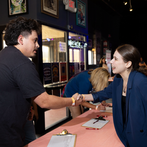 Two people shake hands at an Omaha event.