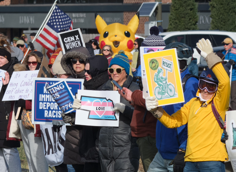 An inflatable Pikachu sits at the back of a crowd at a Lincoln No Kings protest.
