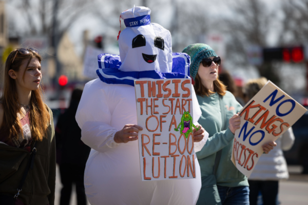 A ghostbusters character holds a sign at a Nebraska No Kings protest.