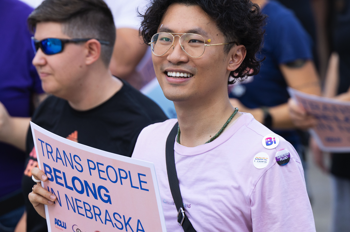 A Nebraskan holds a sign reading "Trans people belong in Nebraska" at a rally outside the Nebraska State Capitol. Photo by Rebecca Gratz for the ACLU of Nebraska.