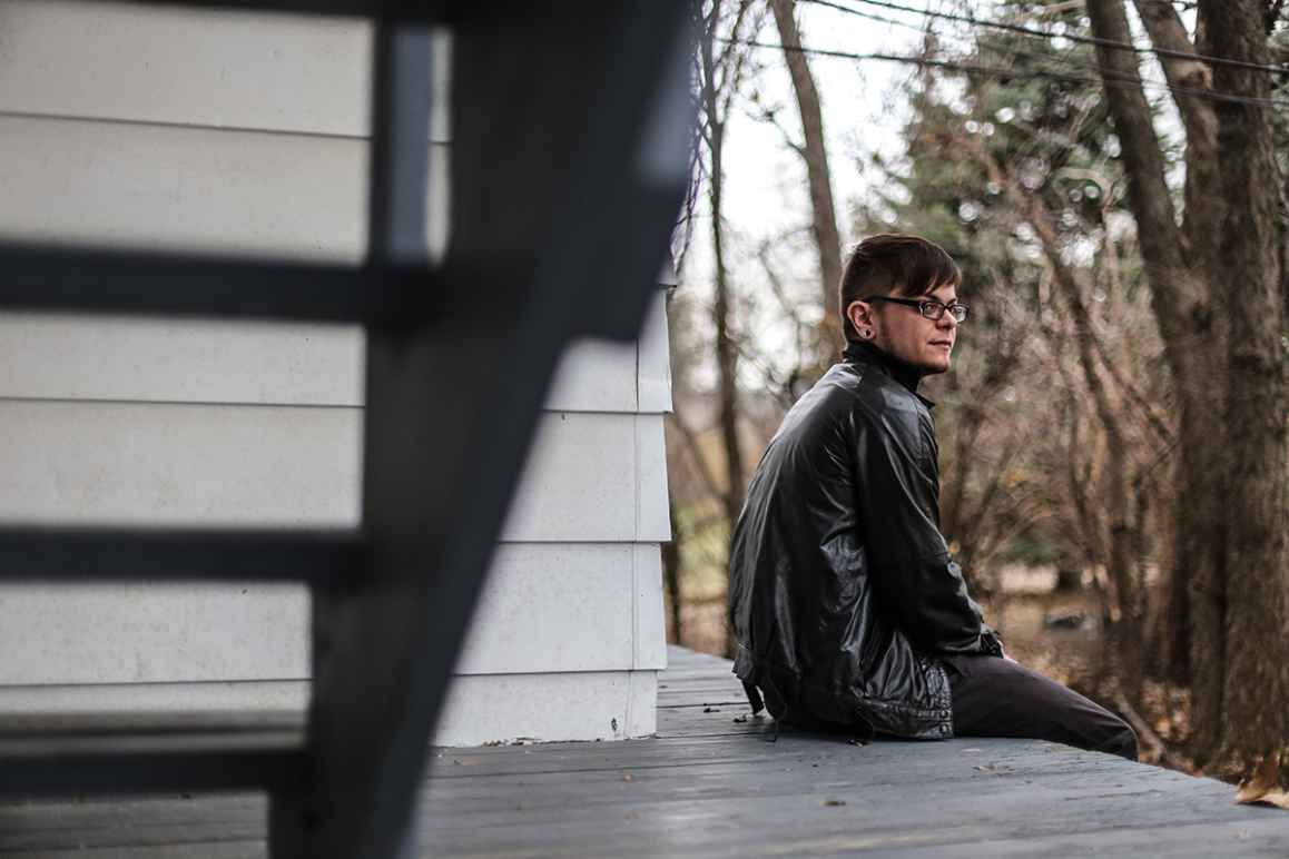 Dylan sitting on his porch outside of his home.