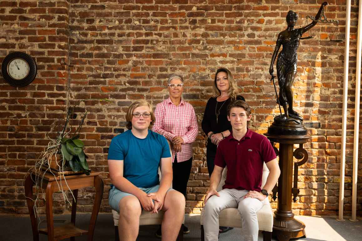 Erin Porterfield and Kristin Williams stand behind their sons in a group photo.