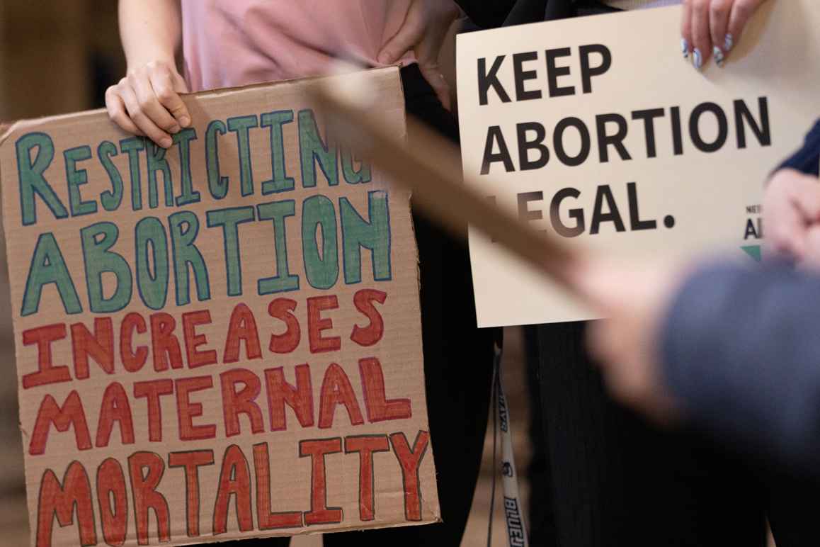 Nebraskans hold signs in support of abortion rights ahead of a committee hearing on six-week abortion ban LB 626.