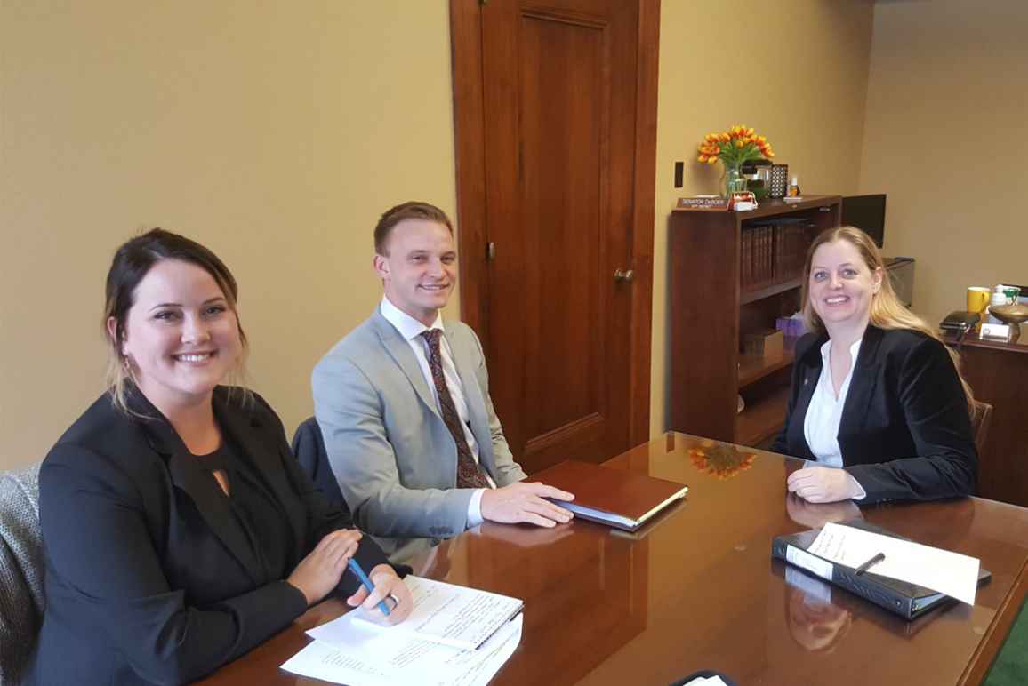 Nebraska Law Civil Clinic students Erin Olsen, an ACLU law clerk, and Josh Waltjer meet with Senator Wendy DeBoer to discuss a bill the Senator has introduced to clarify Nebraska's conviction set-aside law.