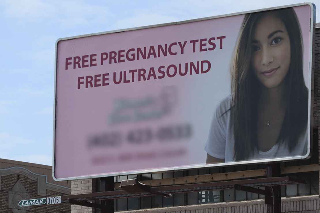 A crisis pregnancy center advertises in Lincoln, promoting free pregnancy tests and ultrasounds.