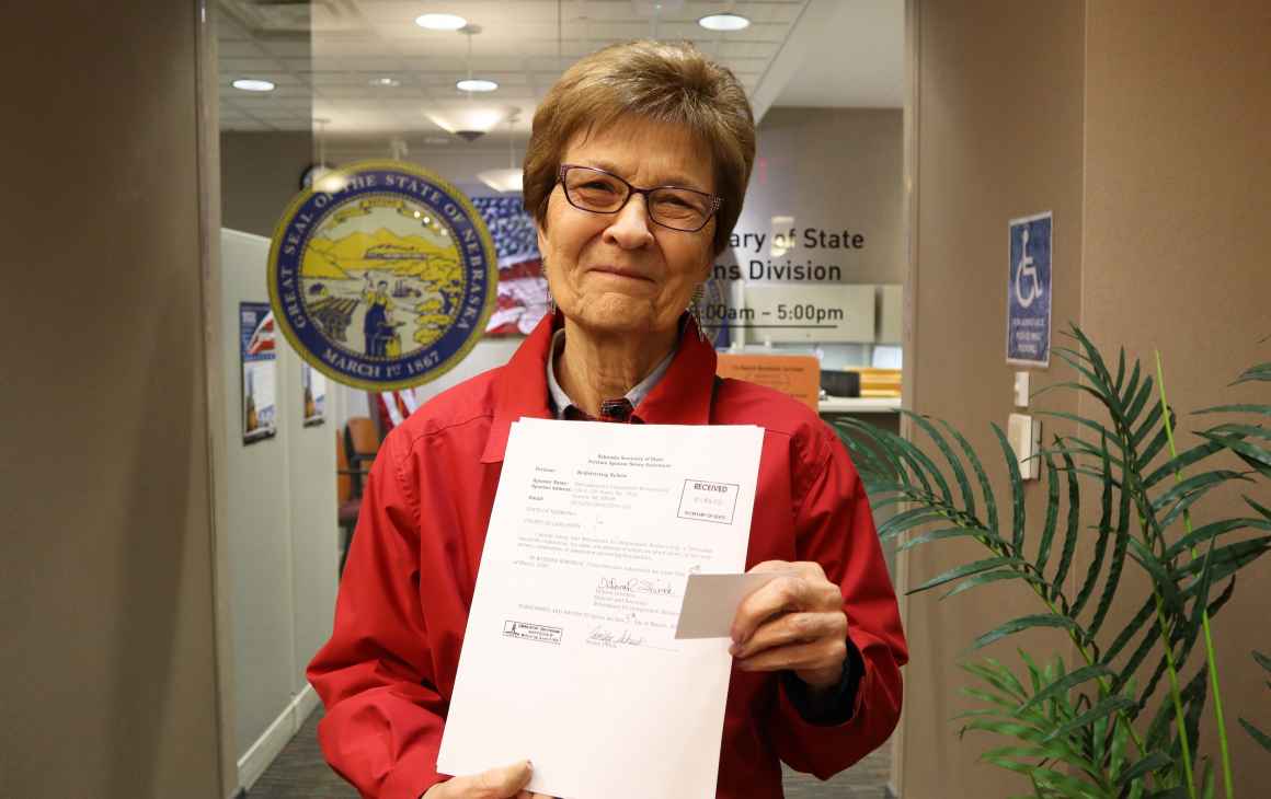 Campaign co-chair and former State Sen. DiAnna Schimek displays a copy of filed paperwork outside of the Nebraska Secretary of State’s Office.