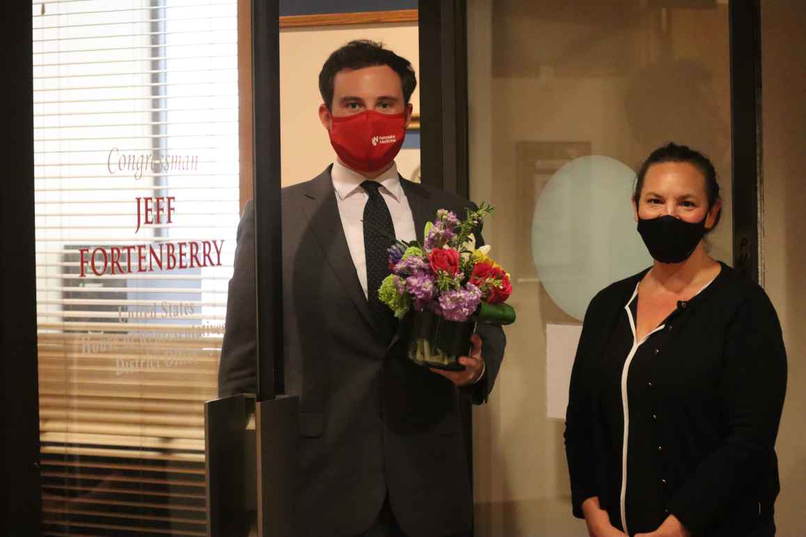 ACLU of Nebraska Executive Director Danielle Conrad drops off flowers at Rep. Fortenberry's district office in Lincoln.