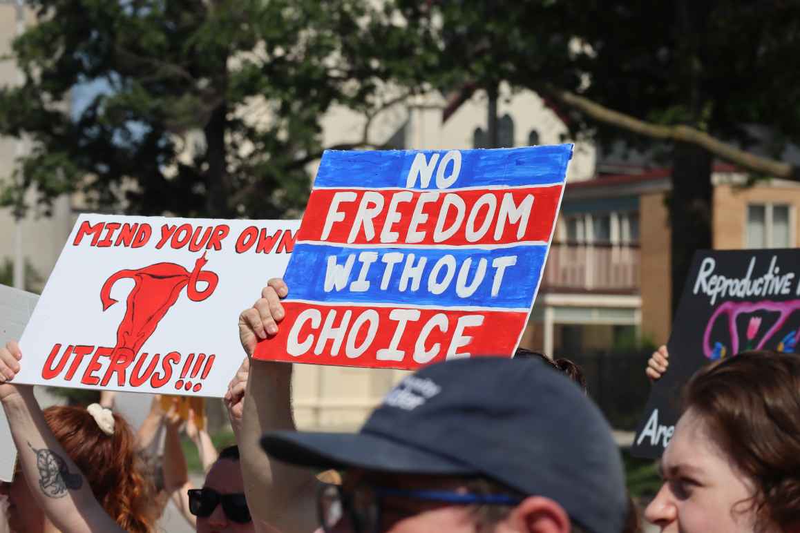 Nebraskans hold protest signs at an abortion rights rally in Lincoln.