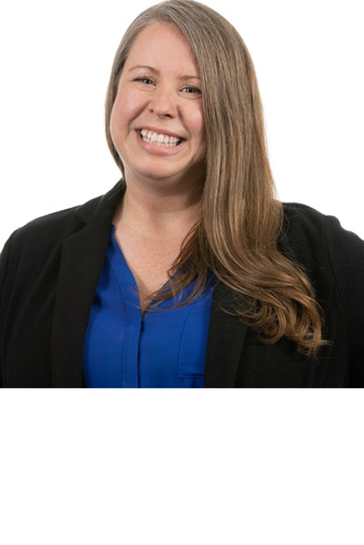 This image of Mindy Rush Chipman shows a smiling woman with white/light skin tone and slightly longer than shoulder-length brown-grey hair. Mindy is wearing a blue button up shirt with a black suit jacket.