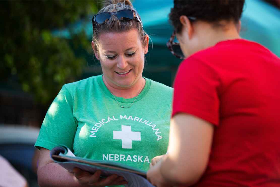 Campaign volunteer Nicole Hochstein collects a petition signature in Omaha.