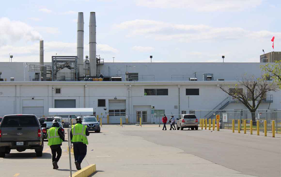 Two workers walk toward the Tyson Foods processing plant in Dakota City, Nebraska.