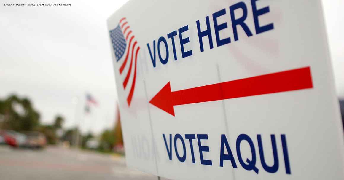 Sign near a polling place saying "Vote Here" and "Vote Aqui"