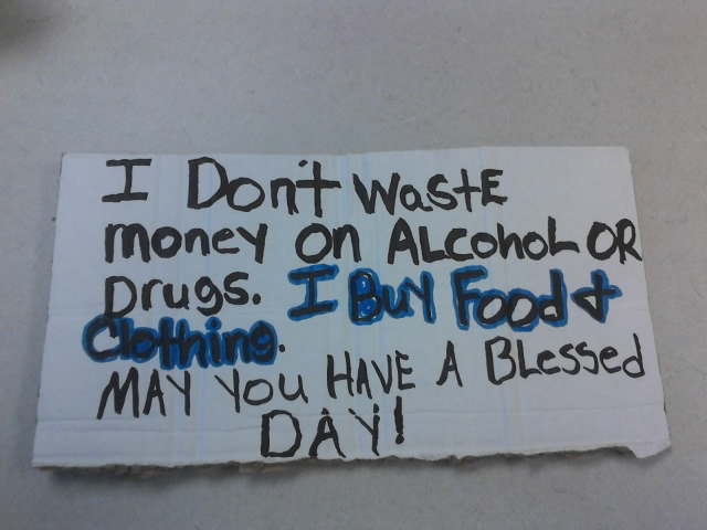 Reads: I don't waste money on alcohol or drugs. I buy food and clothing. May you have a blessed day!