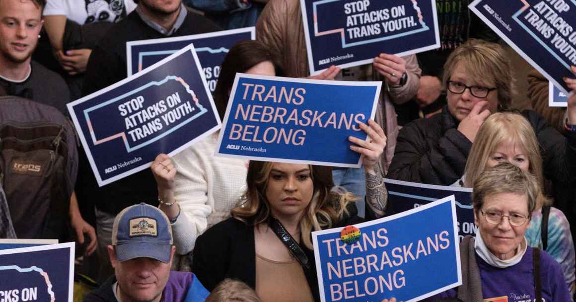 Nebraskans rally alongside Nebraska state senators against legislation targeting trans youth.