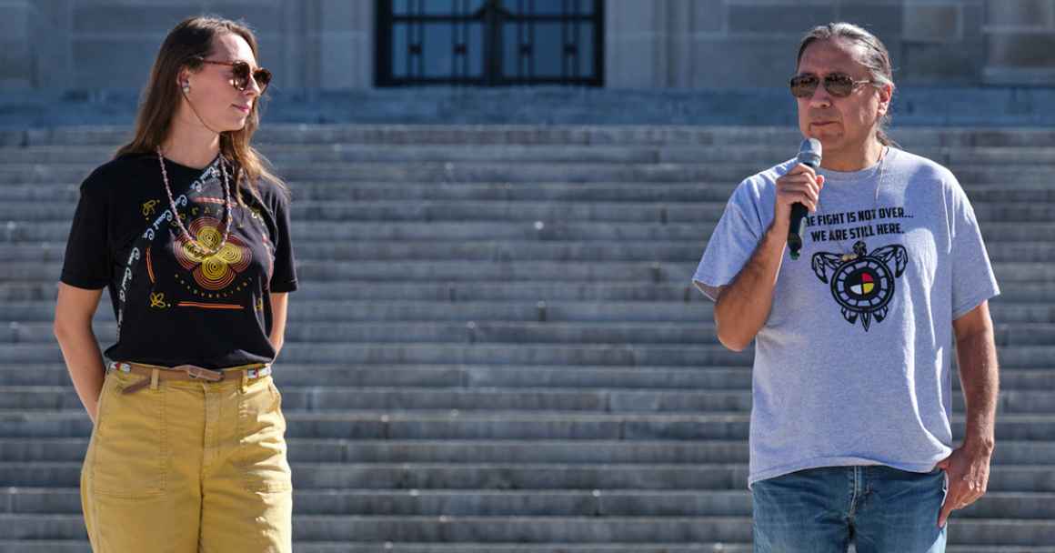 Erin Poor and Kevin Abourezk speak at a solidarity rally