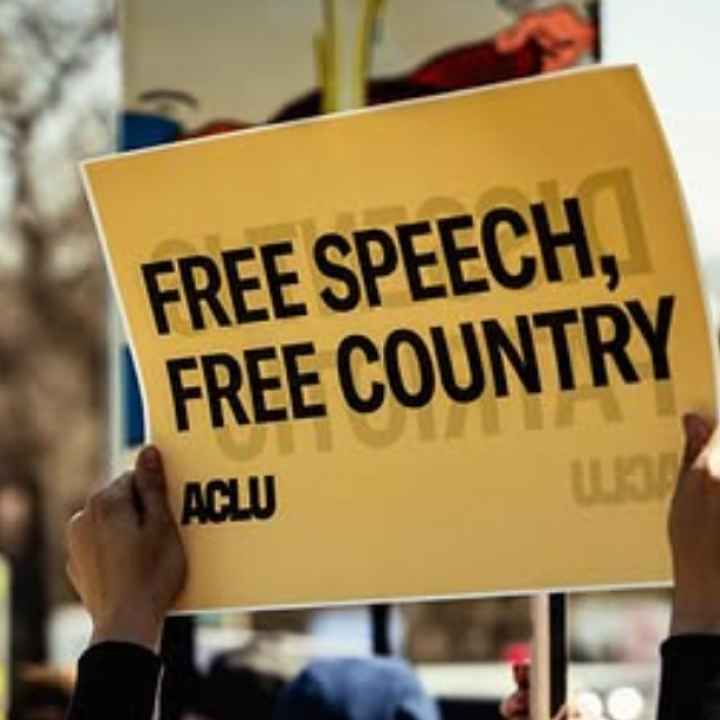 Free speech, free country A rally attendee in Omaha holds an ACLU sign reading "FREE SPEECH, FREE COUNTRY."