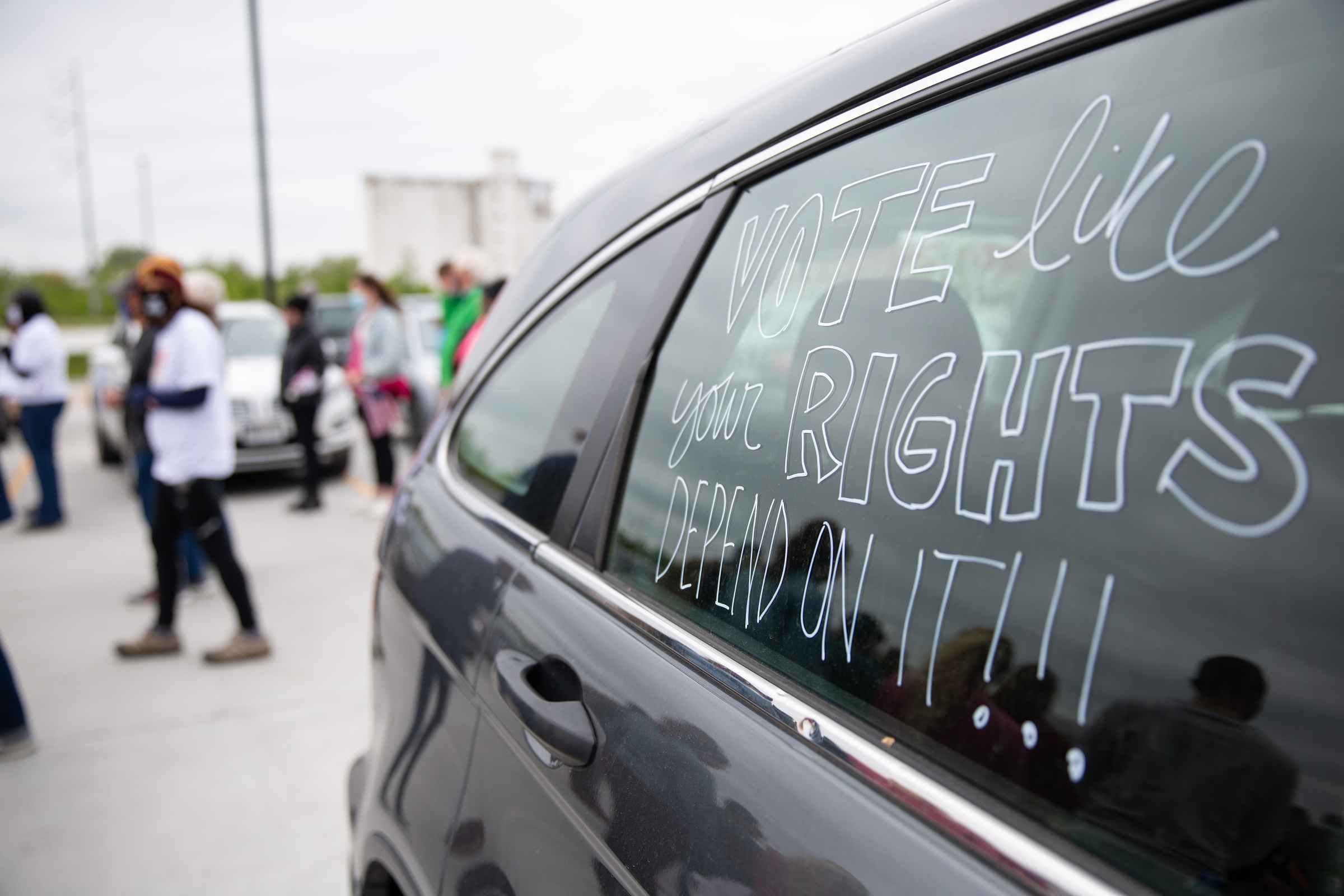 A car reads "Vote Like Your Rights Depend on It!"